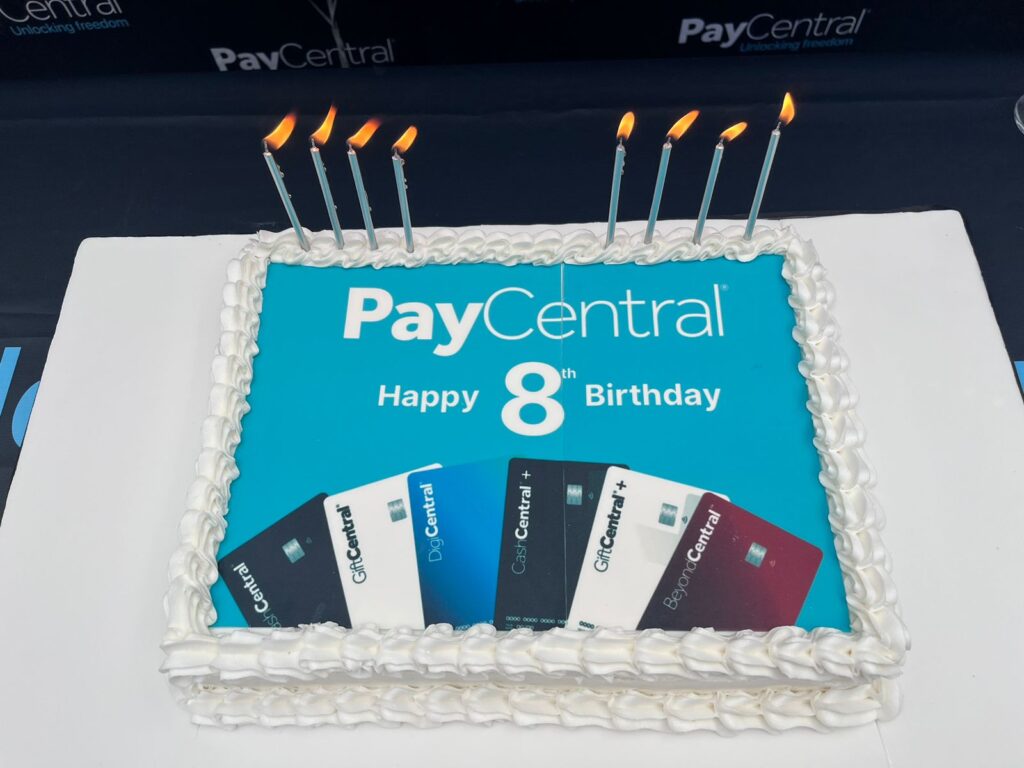 PayCentral eighth anniversary celebration cake with branded design and candles