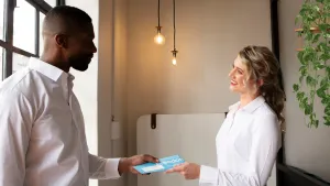 Employee receiving a corporate card from their manager incentive payments