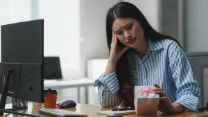 Young Female Staff Member Disappointed With Company Employee Rewards